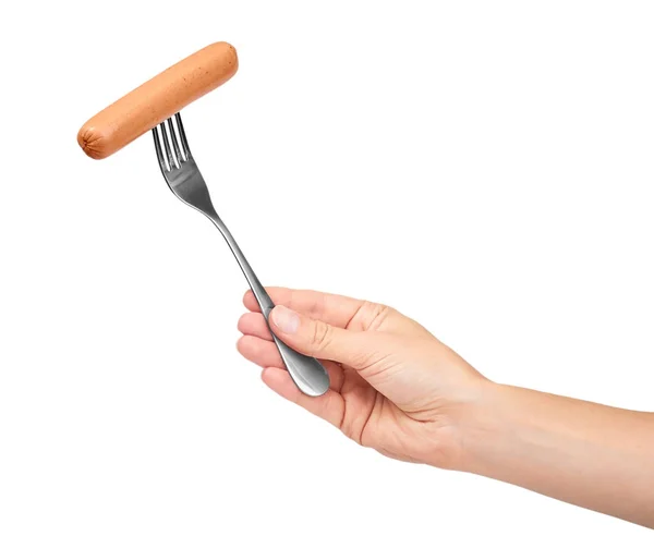 Tangan wanita memegang garpu dengan sosis. Terisolasi pada latar belakang putih — Stok Foto
