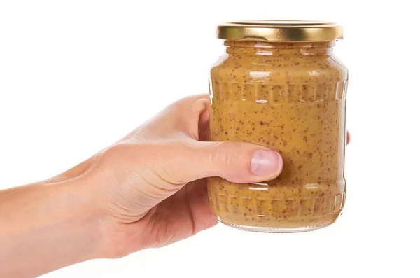 Home made mustard in glass bottle in hand isolated on white background — Stock Photo, Image