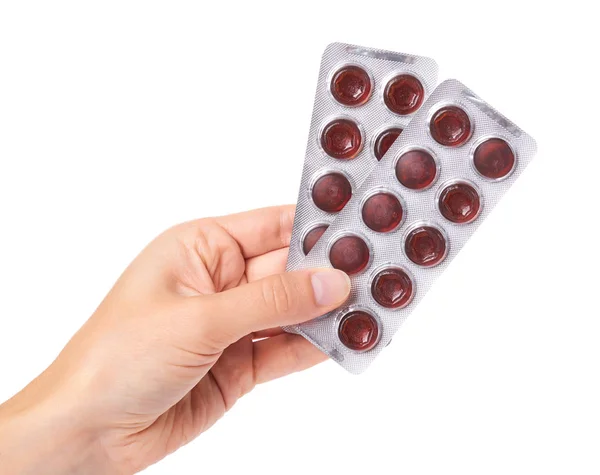Pílulas médicas em blister na mão isolado em fundo branco — Fotografia de Stock