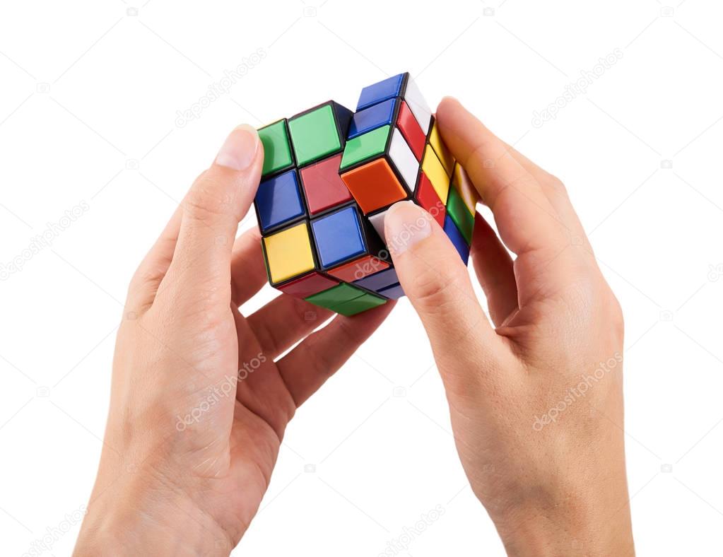 brain game rubik cube in hand isolated on white background