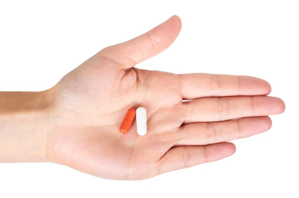 Cápsulas pílulas na mão isolado no fundo branco — Fotografia de Stock