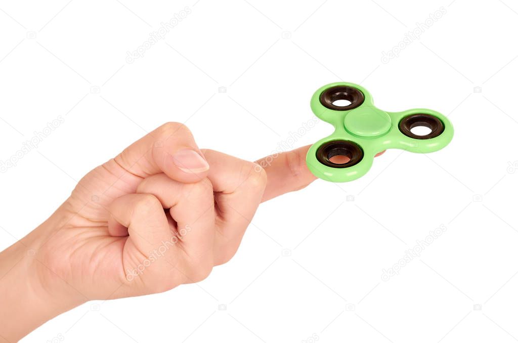 green fidget spinner in hand isolated on white background