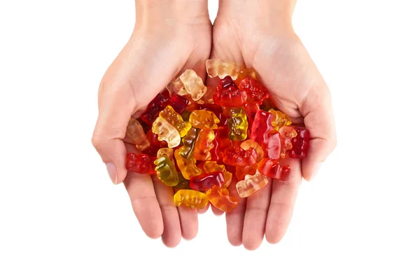 Childhood and jelly bears candies in hand isolated on white background — Stock Photo, Image