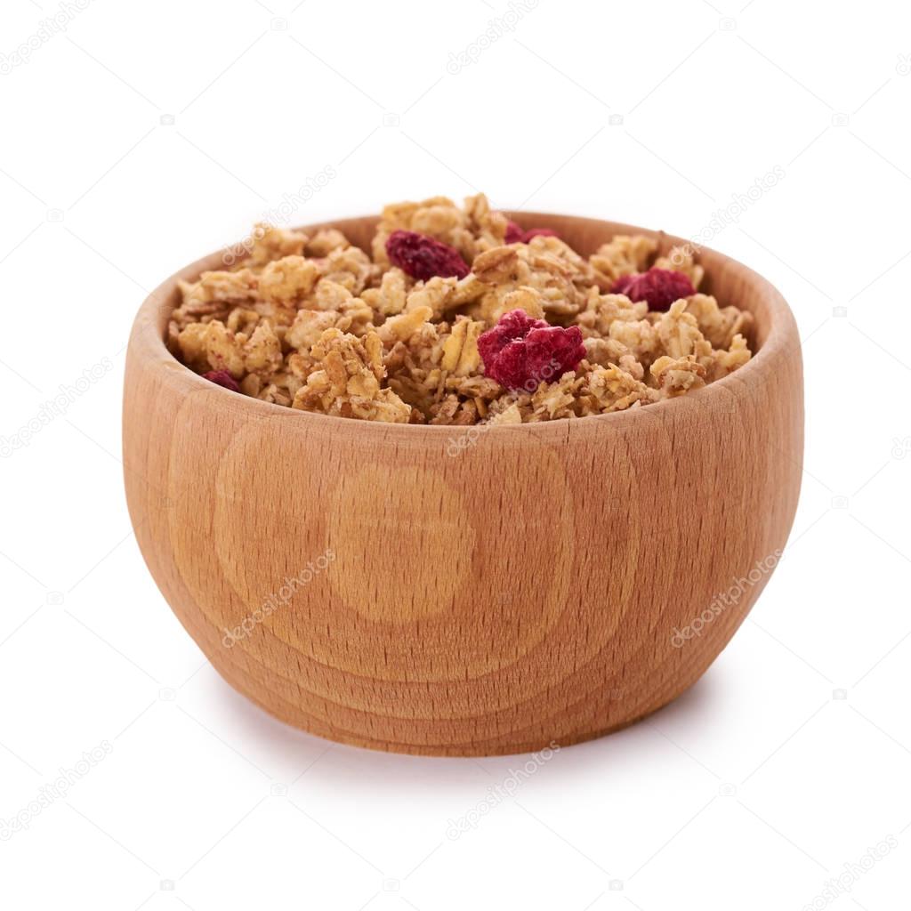 homemade granola with dried fruits in wooden pot isolated on white background