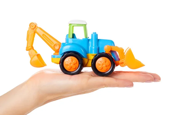 Plastic toy tractor in hand isolated on white background — Stock Photo, Image