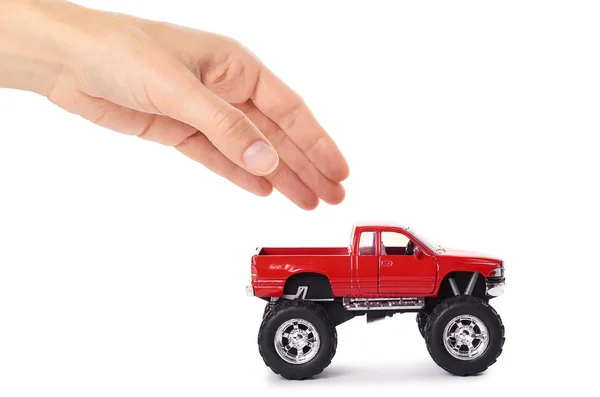 Big metal red toy car offroad with monster wheels in hand isolated on white background — Stock Photo, Image