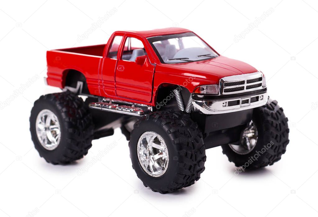 big metal red toy car offroad with monster wheels isolated on white background