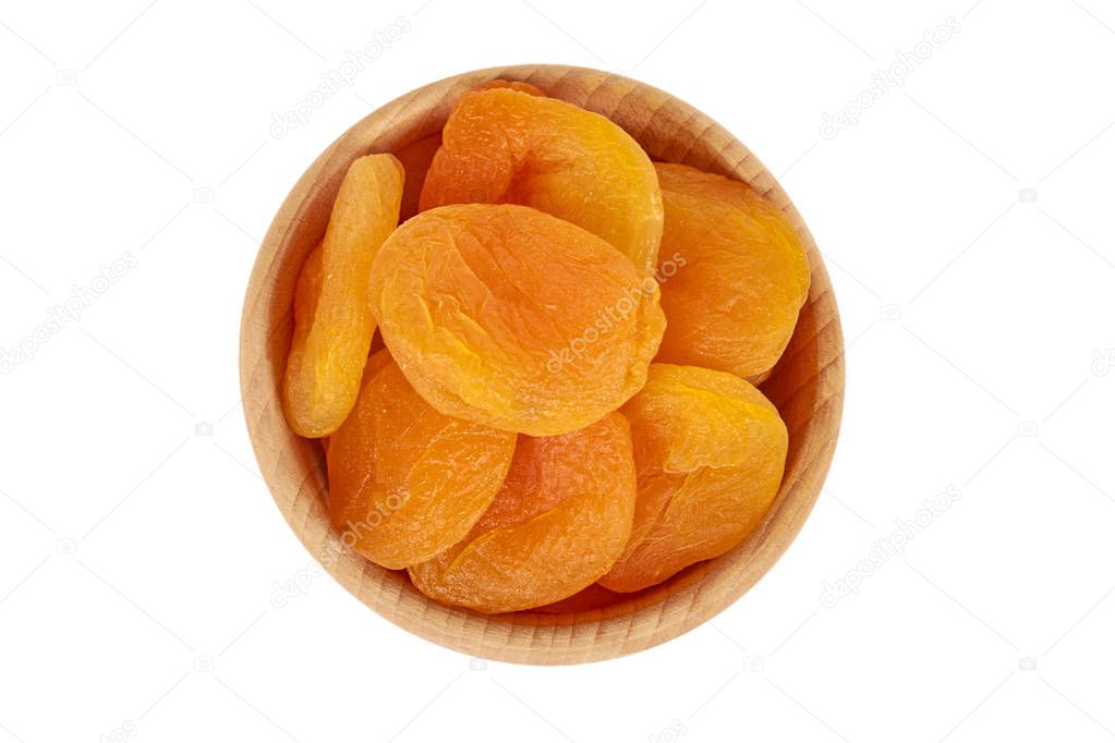 delicious and healthy dried apricots in wooden bowl isolated on white background, healthy sweet snack