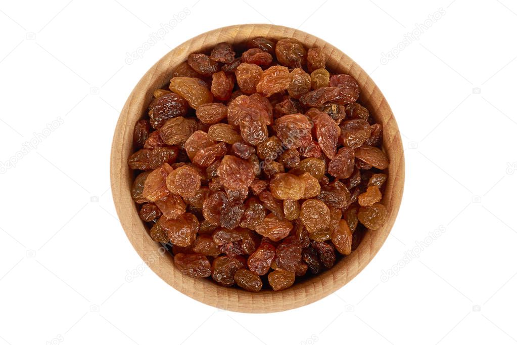 delicious and healthy raisins in hand in wooden bowl isolated on white background, healthy sweet snack