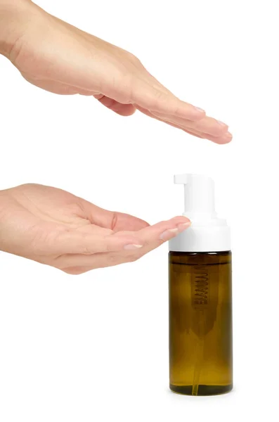Botella de plástico con bomba en mano aislada sobre fondo blanco. Dispensador de espuma para el cuidado facial. Envase con loción corporal . — Foto de Stock