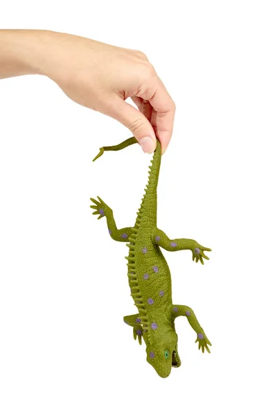 Iguana de brinquedo de silicone na mão isolado no fundo branco. Jogo animal exótico . — Fotografia de Stock