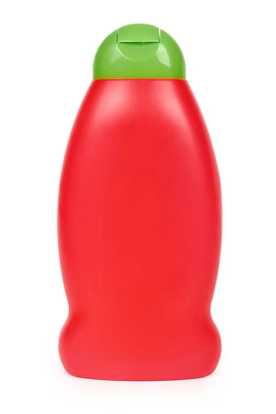 Frasco de plástico vermelho para shampoo isolado no fundo branco. Hydiene e limpeza ideia — Fotografia de Stock