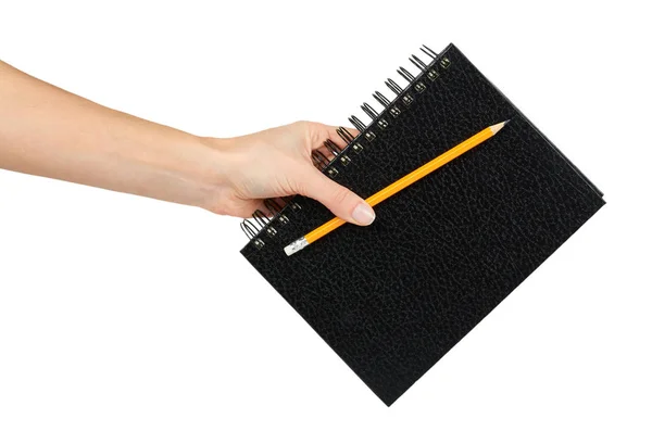 Caderno preto para escrever ou desenhar em espiral na mão, isolado no fundo branco — Fotografia de Stock