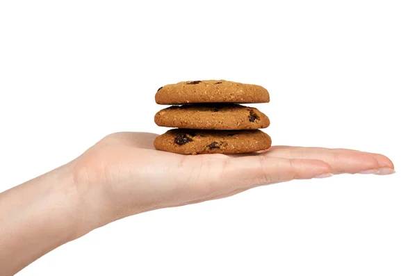 Hausgemachte oragnische Schokoladenkekse mit Rosinen und Kürbiskernen in der Hand. isoliert auf weißem Hintergrund — Stockfoto