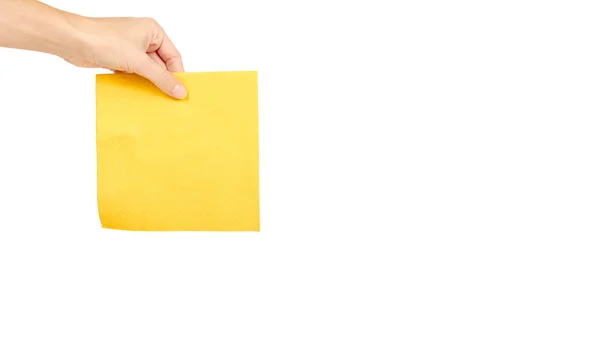 Guardanapo de papel amarelo para alimentos na mão isolado em fundo branco. Cozinha servindo objeto. espaço de cópia, modelo — Fotografia de Stock