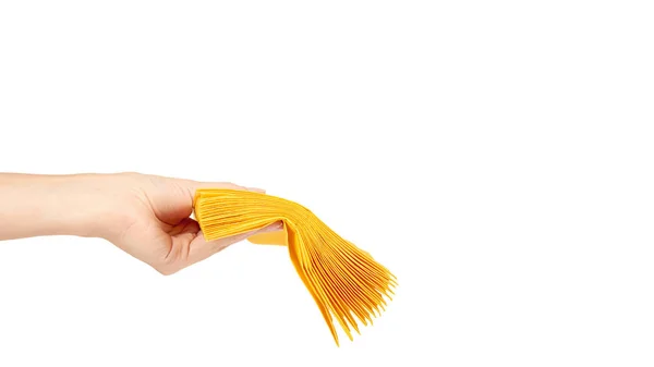 Guardanapo de papel amarelo para alimentos na mão isolado em fundo branco. Cozinha servindo objeto. espaço de cópia, modelo — Fotografia de Stock