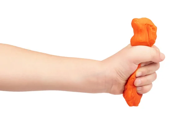 Orange plasticine bar with kid hand, isolated on white background — Stock Photo, Image