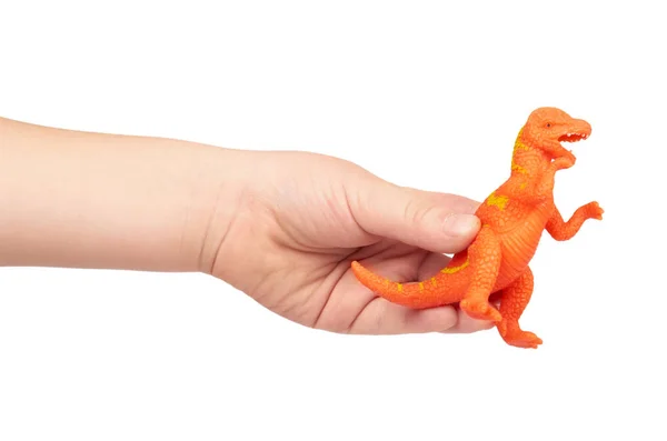 Brinquedo de borracha de dinossauro pré-histórico com mão de criança, isolado no fundo branco — Fotografia de Stock