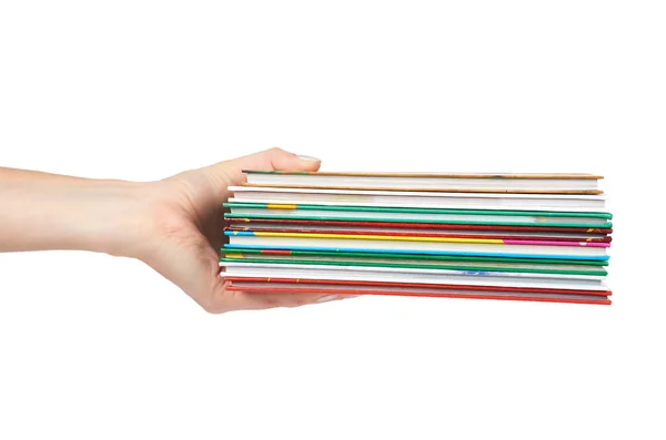 Différents livres colorés en pile avec la main isolée sur fond blanc — Photo