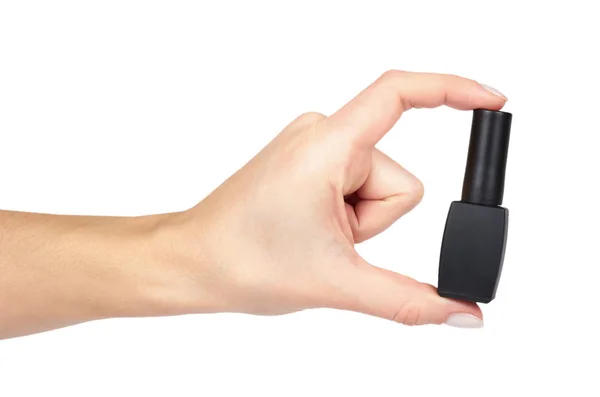 Schwarze Nagellackflasche mit Hand isoliert auf weißem Hintergrund — Stockfoto