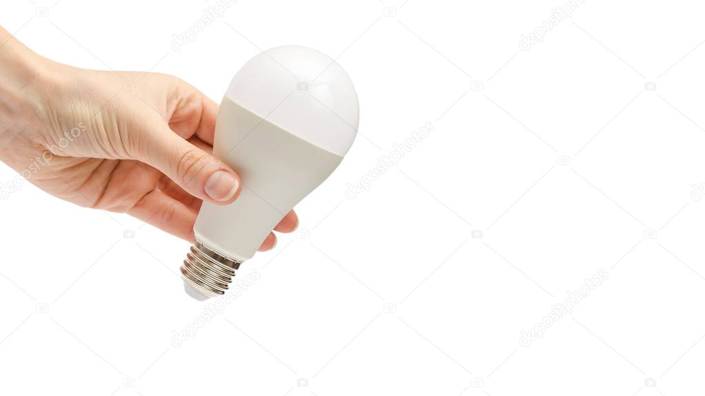 hand of young girl holding low energy lightbulb. Isolated on white background. copy space, template.