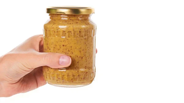 Rumah membuat mustard dalam botol kaca di tangan Terisolasi di latar belakang putih. salin ruang, templat — Stok Foto