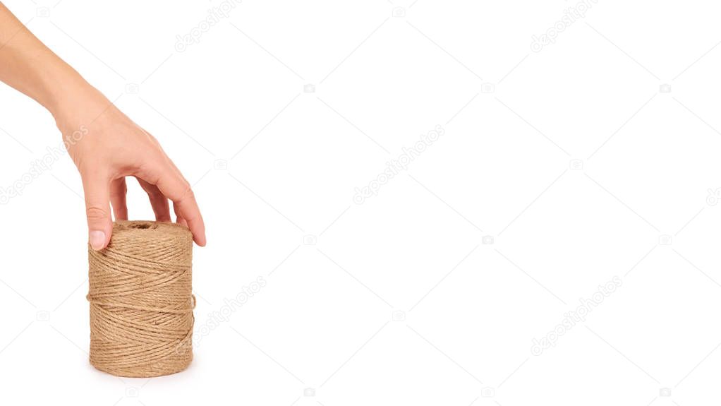 Spool of bale twine isolated in hand on white background. copy space, template