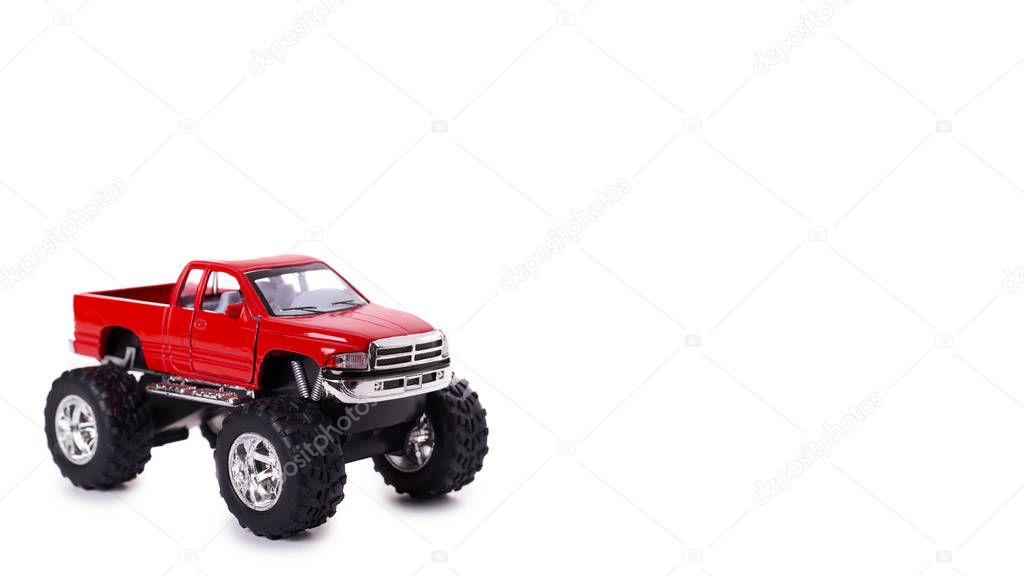big metal red toy car offroad with monster wheels isolated on white background. copy space, template