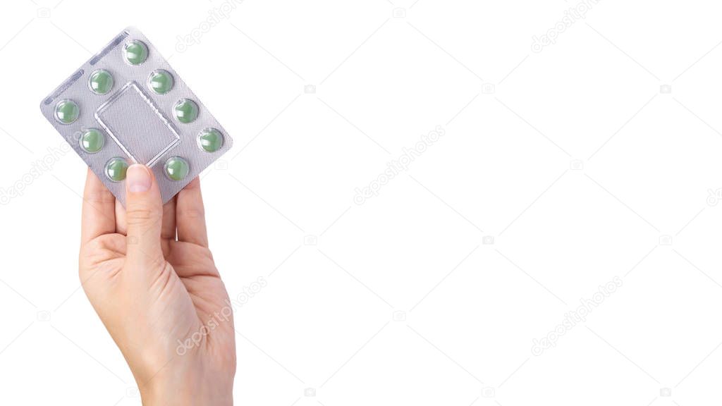 Medicine in tablet package in hand isolated on white background, pills in blister. copy space, template