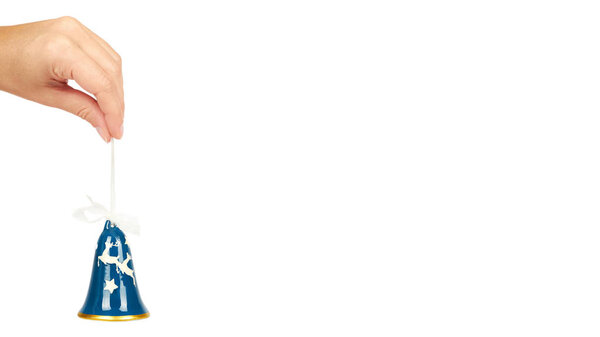 glass ceramic bell, Cristmas decoration in hand isolated on white background. New Year object. copy space, template