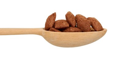 Çikolatalı yastık gevreği, kahvaltı yemeği. Yulaf ve mısırlı gevrek. Tahta kaşık..