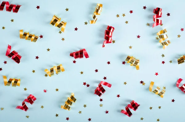 Gekleurde confetti compositie op blauwe achtergrond, feest en viering decoratie. — Stockfoto