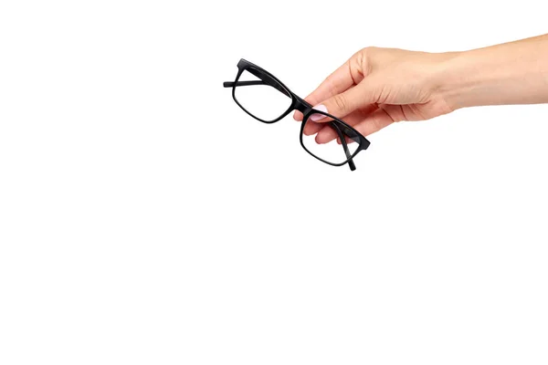 Mano con anteojos negros, herramienta de corrección óptica ocular . — Foto de Stock
