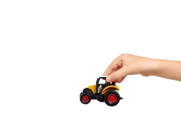 Yellow plastic traktor toy. Farming vehicle, harvest equipment. — Stock Photo, Image