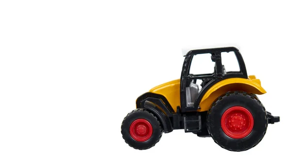 Juguete traktor de plástico amarillo. Vehículo agrícola, equipo de cosecha . — Foto de Stock
