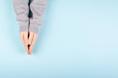 Woman hands in pullover gesture, flat lay.