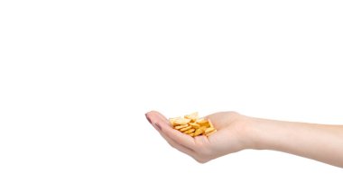 Hand with square mini salted crackers, snack food. Isolated on white background. Copy space, template.