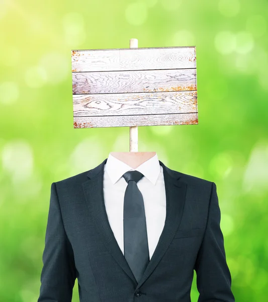Wooden signboard headed businessman — Stock Photo, Image