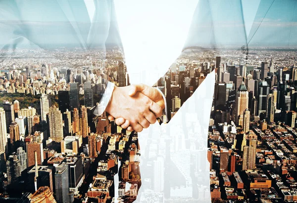 Businessmen shaking hands on city background. Partnership concept. Double exposure — Stock Photo, Image