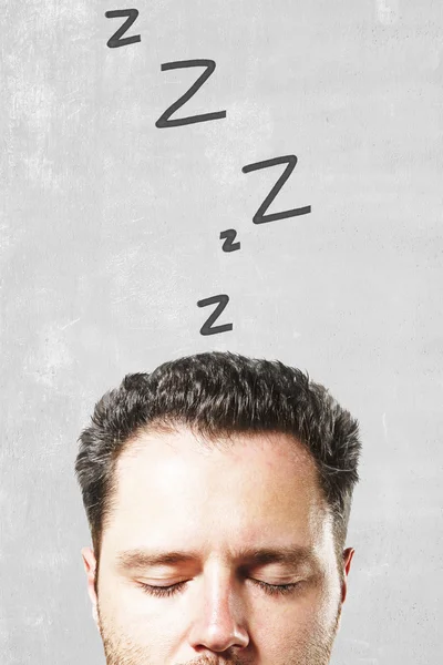 Sleeping man on concrete background — Stock Photo, Image