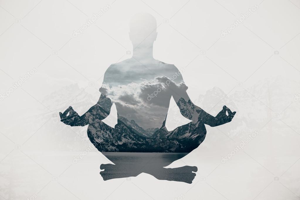 Meditating businessman silhouette on landscape background. Relaxation concept