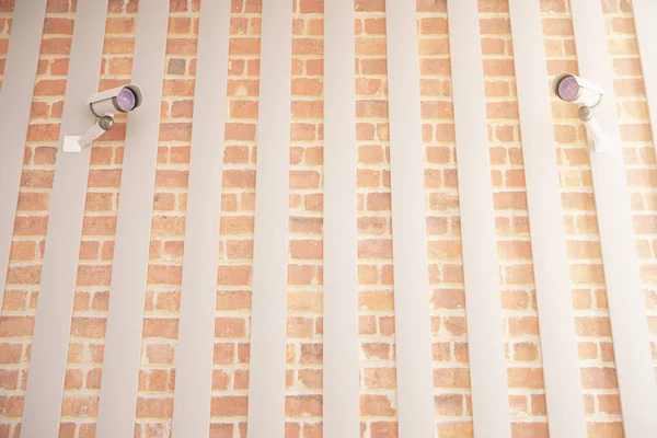 Brick wall with cameras — Stock Photo, Image