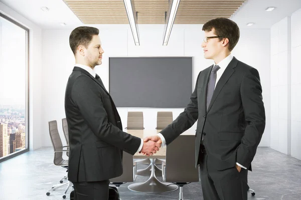 People shaking hands in conference room Royalty Free Stock Photos