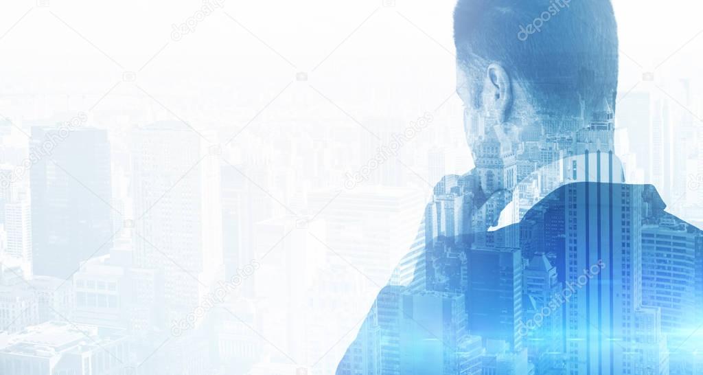 Back view of thoughtful businessman on city background. Double exposure. Research concept
