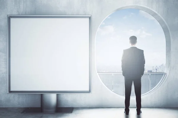 Man in room with square banner — Stock Photo, Image