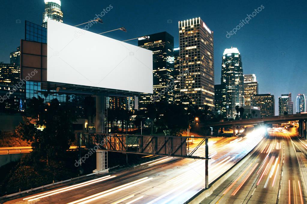 Side view of blank white billboard in nighttime city. Ad concept. Mock up, 3D Rendering