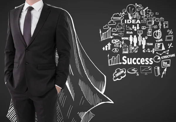 Man with drawn cape and business sketch on dark background. Leadership concept