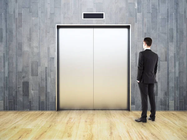 Thoughtful man looking at elevator — Stock Photo, Image