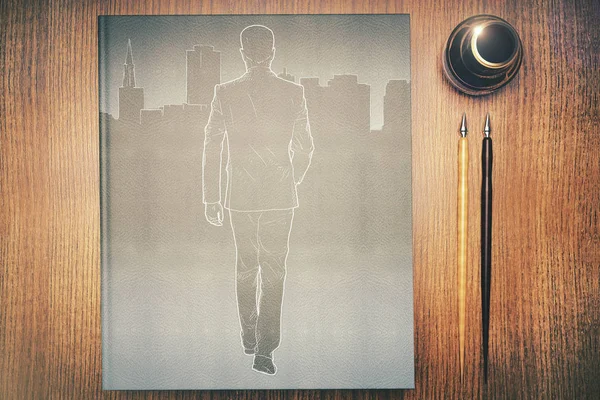 Top view of wooden desk with supplies and abstract drawing of businessman walking towards city. — Stock Photo, Image