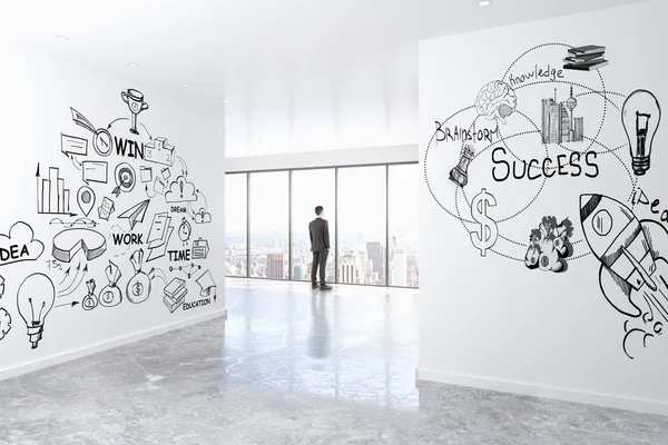 Joven hombre de negocios mirando por la ventana en el interior de hormigón con vista a la ciudad y dibujo de negocios en las paredes. Concepto de liderazgo. Renderizado 3D — Foto de Stock